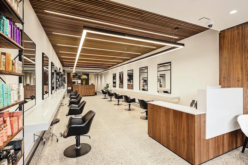 The Tumi Hair salon floor on Bridge Road, Richmond — natural light, quiet pace, a small senior team mid-service.